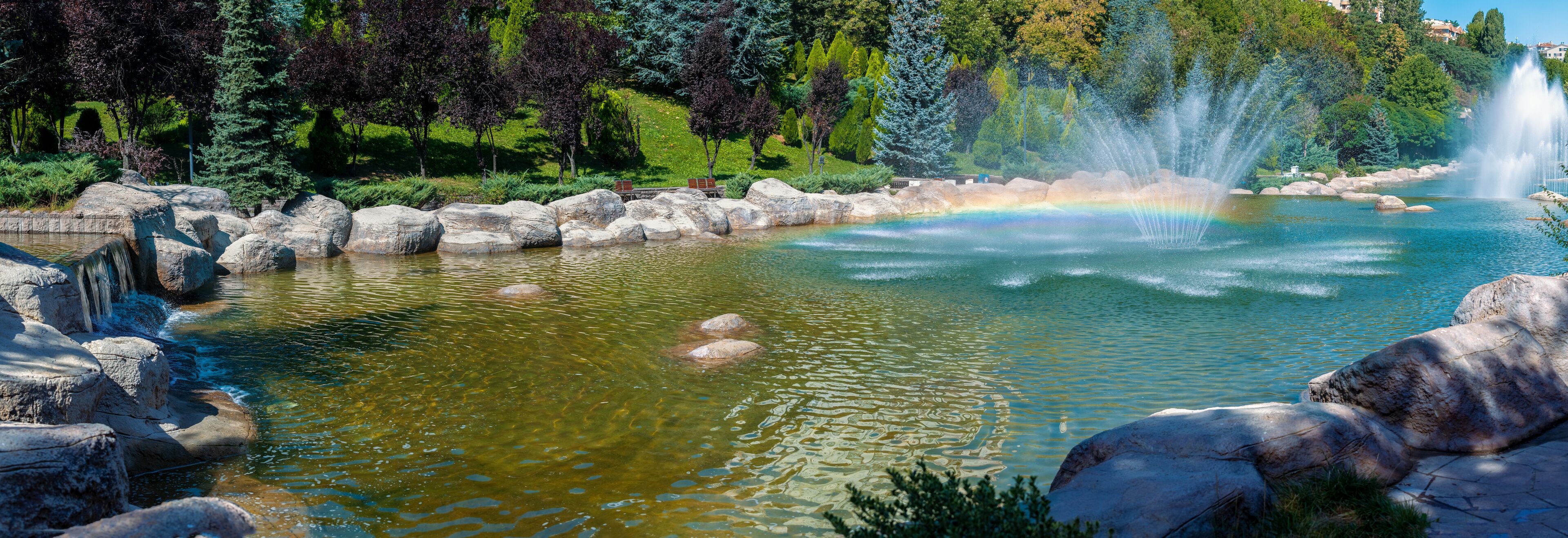Beautiful panoramic view of Dikmen Valley Park | Dikmen Vadisi Parki in Ankara, Turkey. Thousands of trees, decorative waterfall, rocks, water fountains in the big ornamental pool.