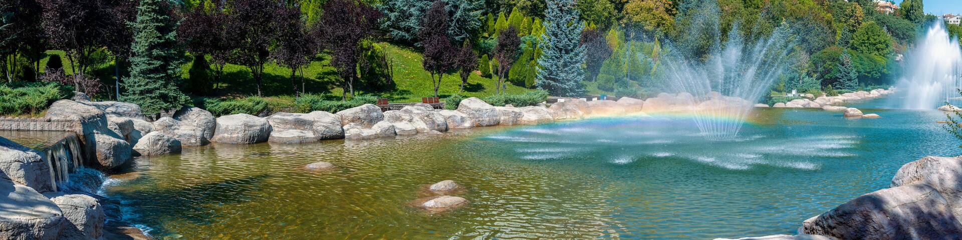 Beautiful panoramic view of Dikmen Valley Park | Dikmen Vadisi Parki in Ankara, Turkey. Thousands of trees, decorative waterfall, rocks, water fountains in the big ornamental pool.