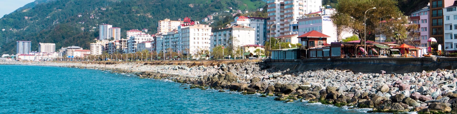 Turkey.Hope in the Artvin silt. Provincial city on the Black Sea coast. High snow capped mountains on a background of a summer landscape with colorful houses of the city of Hopa