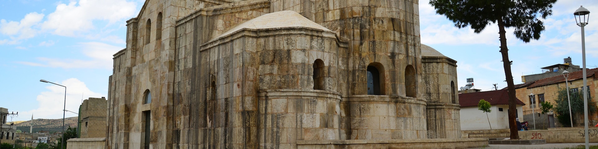 A historic stone building with a dome and arched windows.