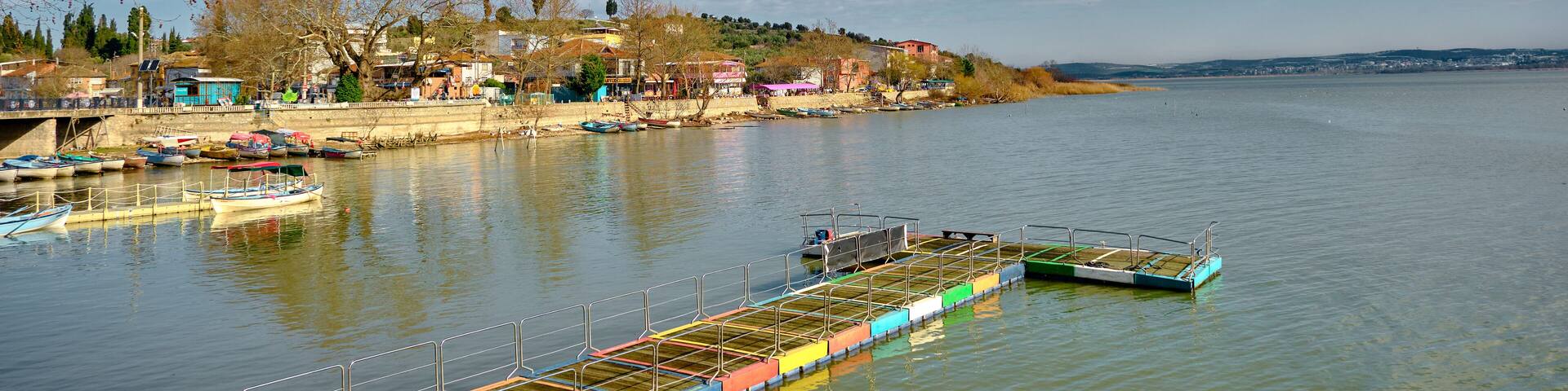 Gölyazı (Apolyont), uluabat lake, Bursa Turkey. 22.01.2021. Panoramic view of uluabat lake and colorful small port and town view with huge mountain backgrdıun.
