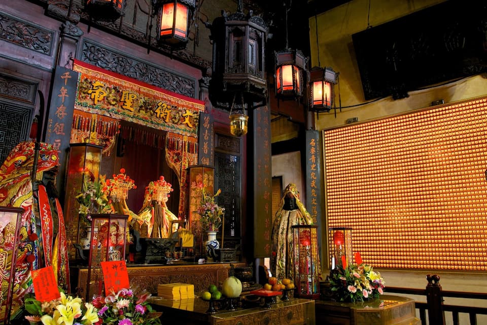 A traditional Chinese altar with intricate decorations, incense burners, and offerings.