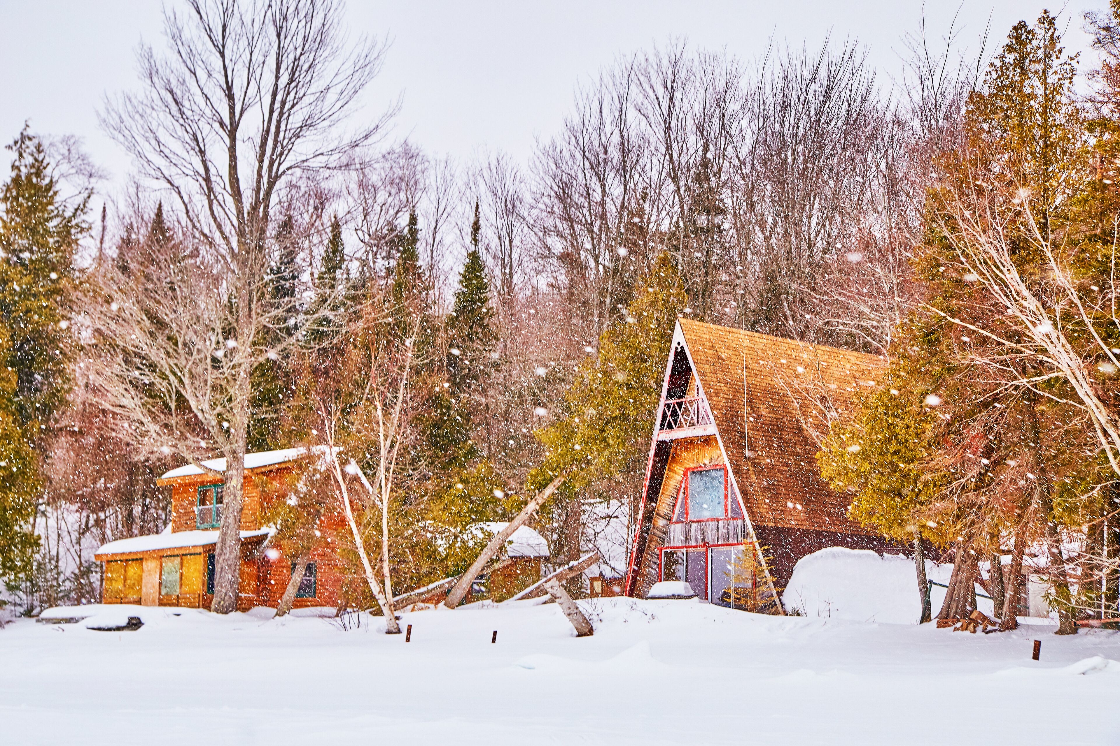 Lake cabins abandoned on coast during winter with frozen lake
