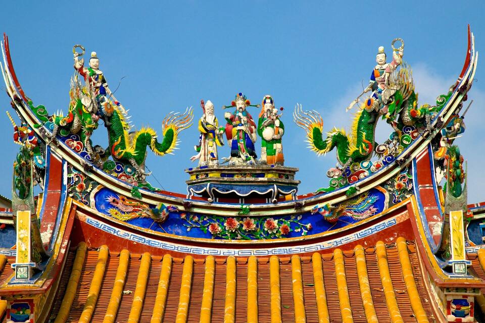 Ein traditionelles chinesisches Dach mit aufwendiger Dekoration und Drachenskulpturen.