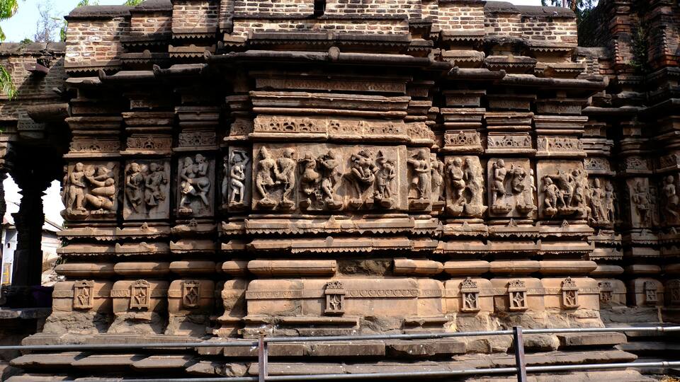 A detailed stone temple with intricate carvings and stepped architecture.