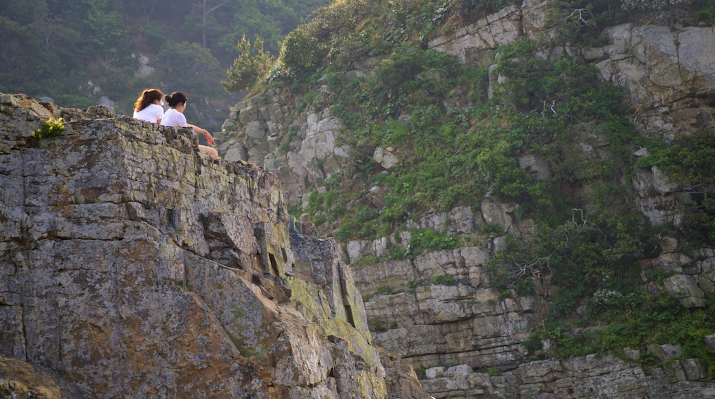 Sinseondae Observatory featuring rugged coastline and a gorge or canyon as well as a couple