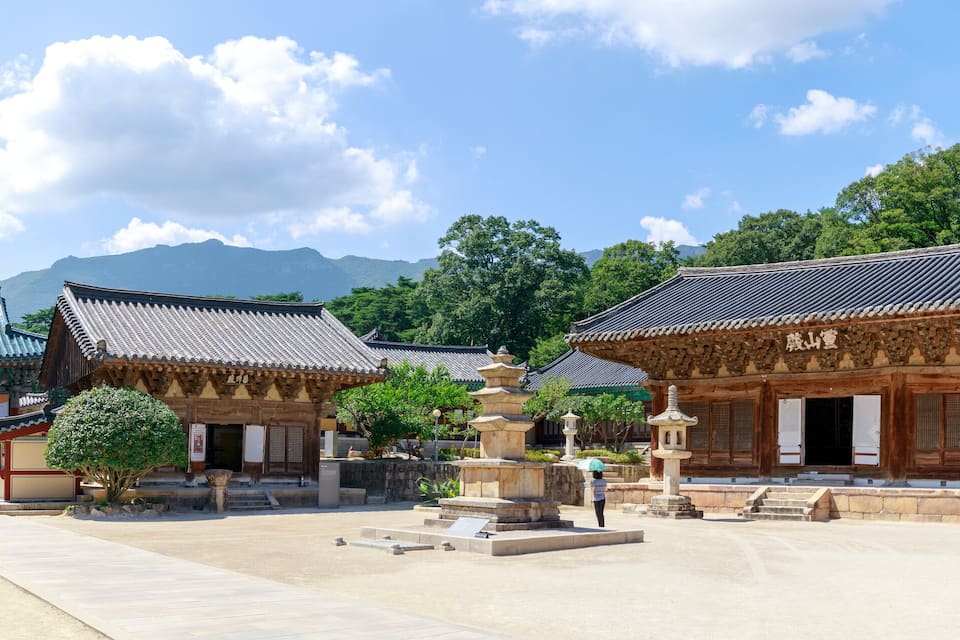 Traditional Korean architecture with ornate roofs and stone buildings.
