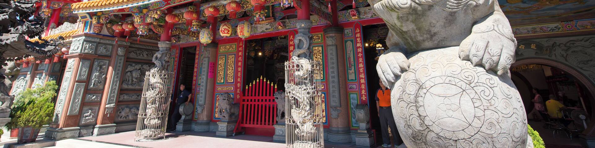 A traditional Chinese temple with ornate architecture, including colorful roofs and statues.