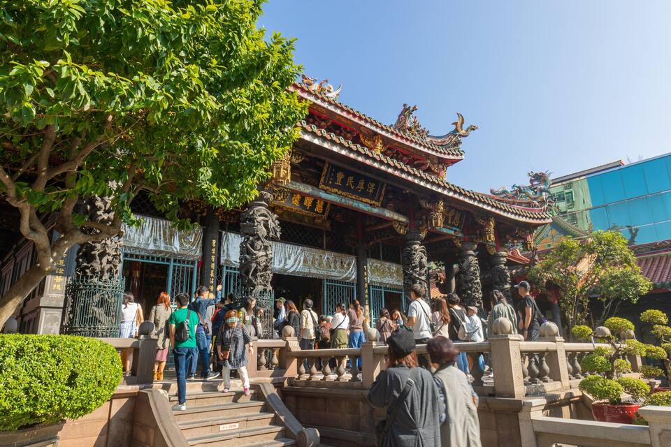 A traditional Chinese temple with ornate architecture, including a dragon roof and intricate carvings.