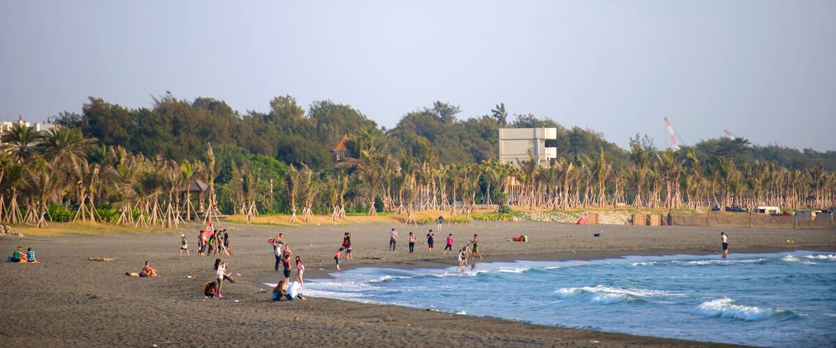 Cijin Seaside Park featuring a sandy beach as well as a small group of people