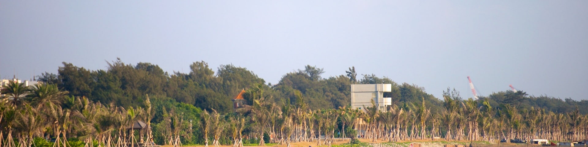 Cijin Seaside Park featuring a sandy beach as well as a small group of people