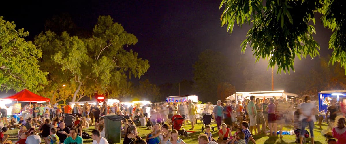 Town Beach showing a park, night scenes and markets