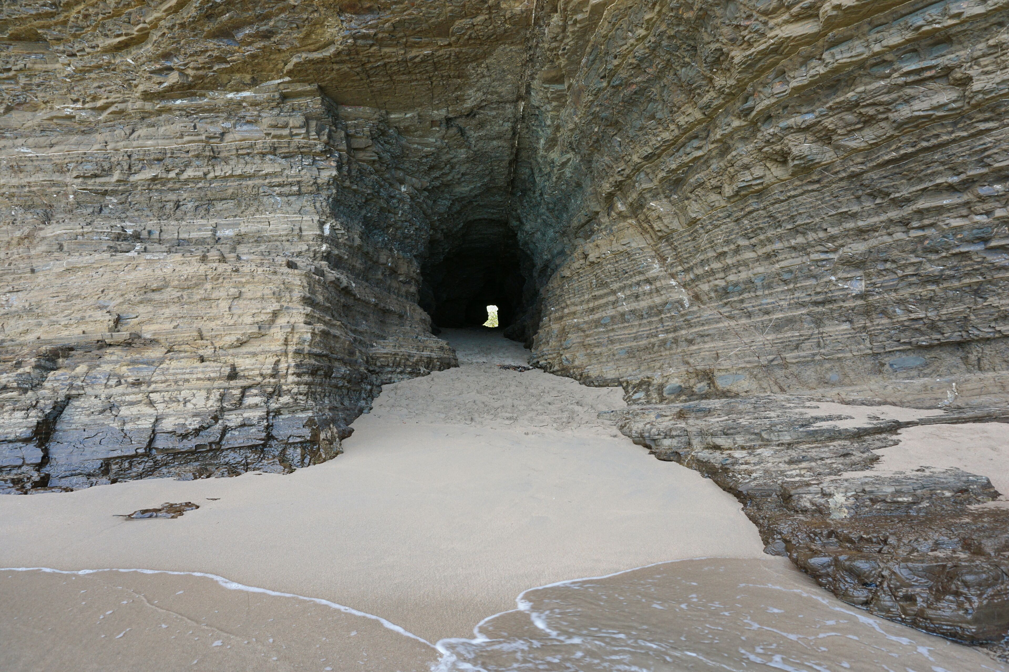 Tunnel in the rock on the coast, connecting beaches of La Roche Percee to Turtle Bay, Bourail, Grande Terre, New Caledonia, south Pacific
