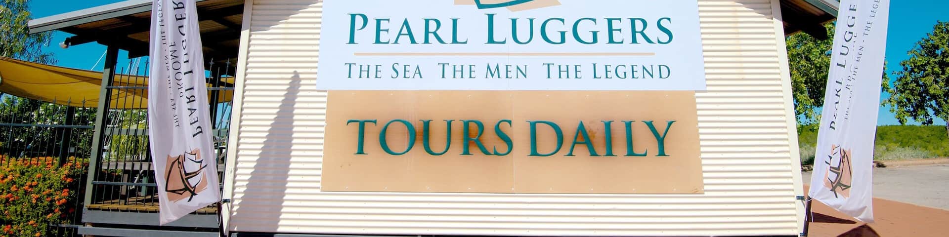 Pearl Luggers Museum showing signage and a house