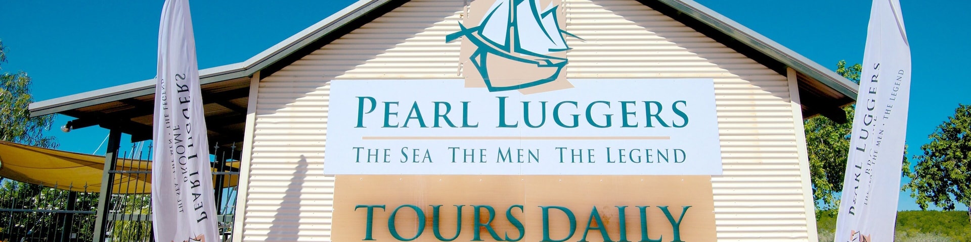 Pearl Luggers Museum showing signage and a house