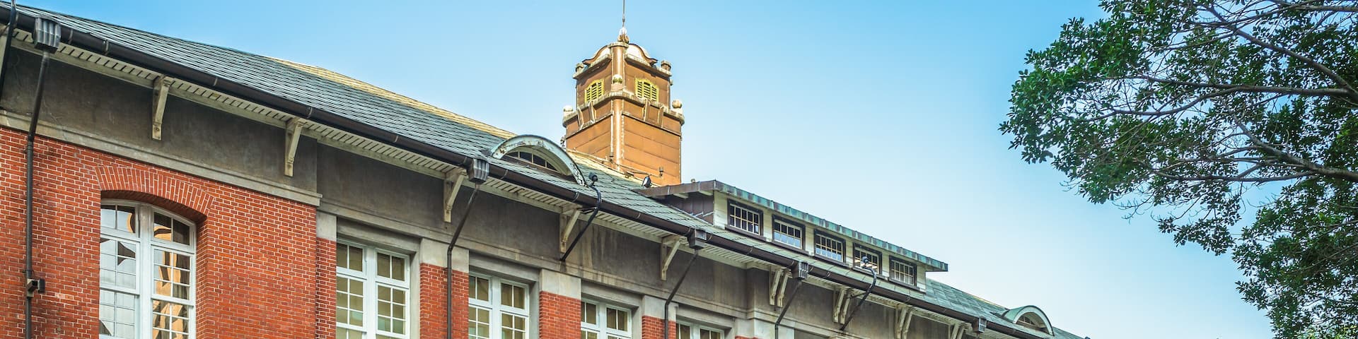 A red brick building with white windows and a clock tower.