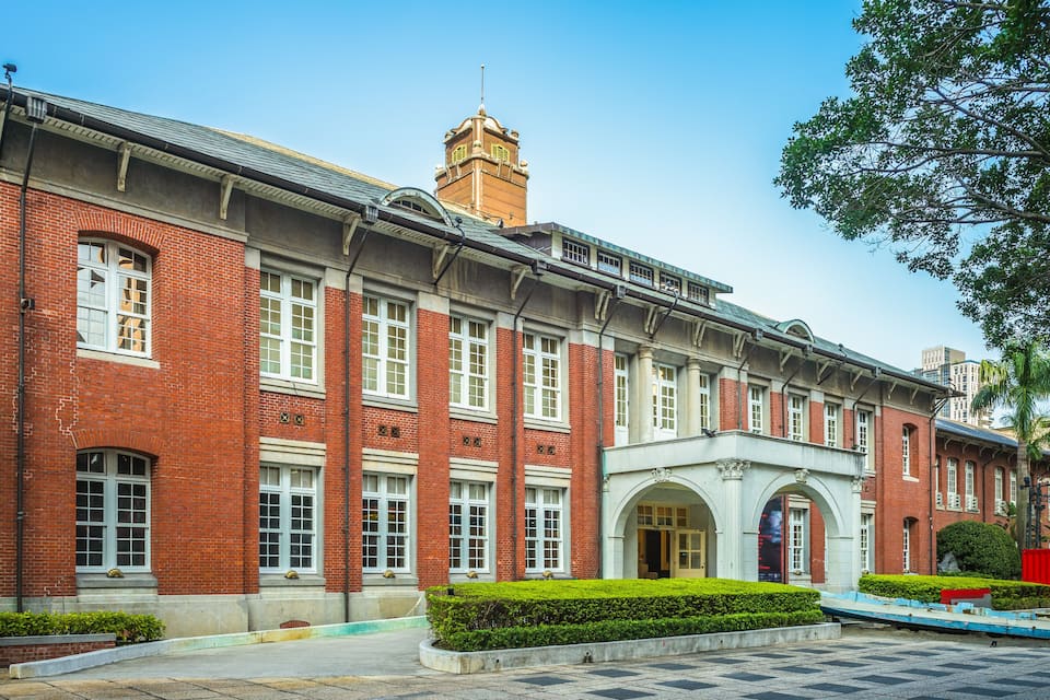 A red brick building with white windows and a clock tower.