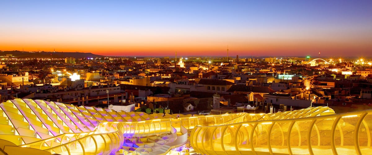 Metropol Parasol showing a sunset, modern architecture and a city