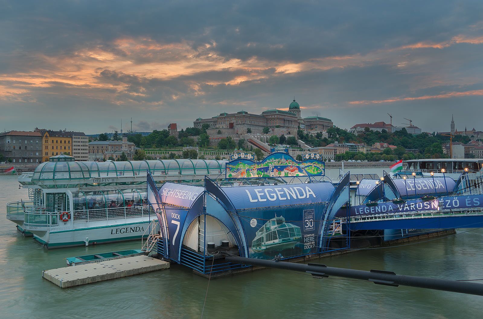 A ferry dock with the name 'LEGEND' and a colorful mural on the side.