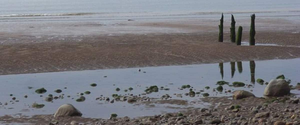 The beach at Crosscanonby Looking across the Solway Firth to Criffel, the most prominent of the Scottish hills visible from Cumbria. The tide is quite high and on the way out.