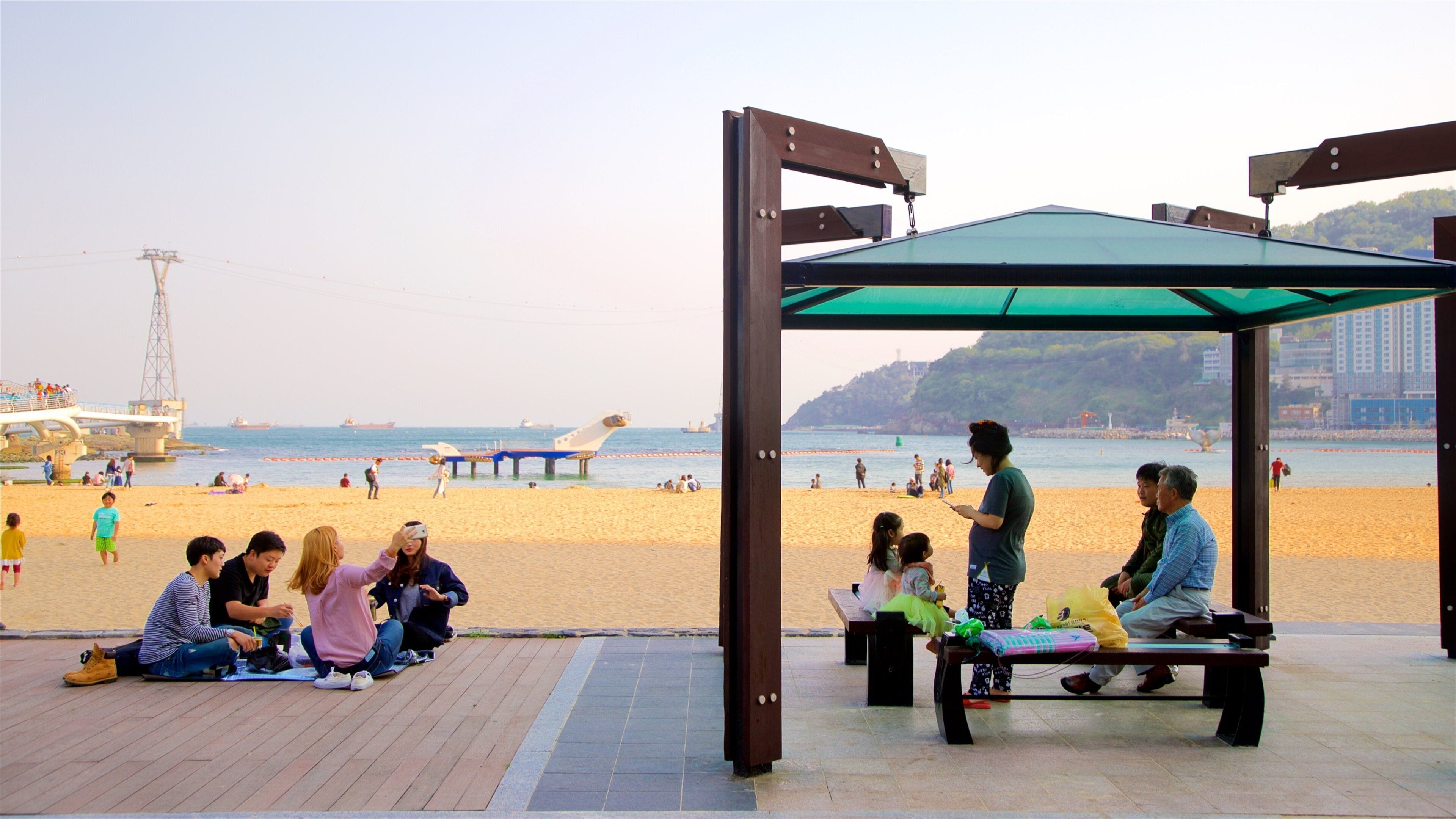 Songdo Beach featuring general coastal views, a sunset and a beach