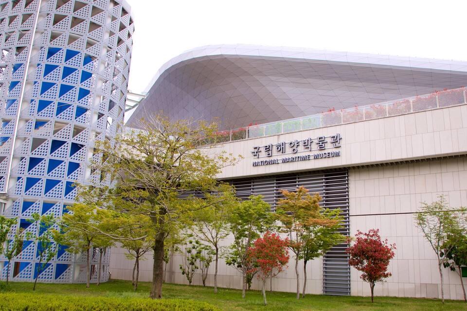 The National Maritime Museum building with a modern design, surrounded by trees and a distinctive tower structure.