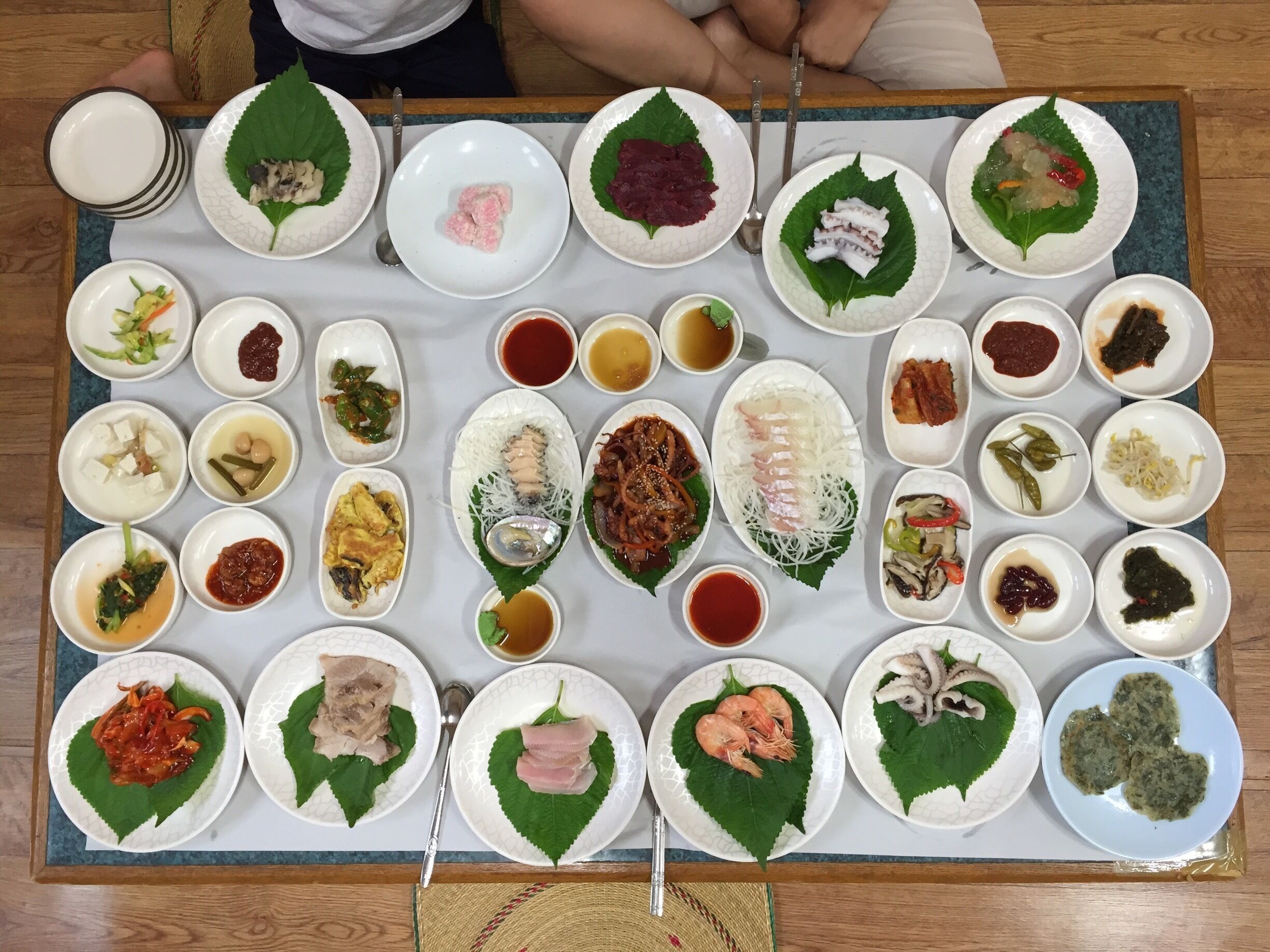 A variety of dishes arranged on a table, including plates with food and condiments.