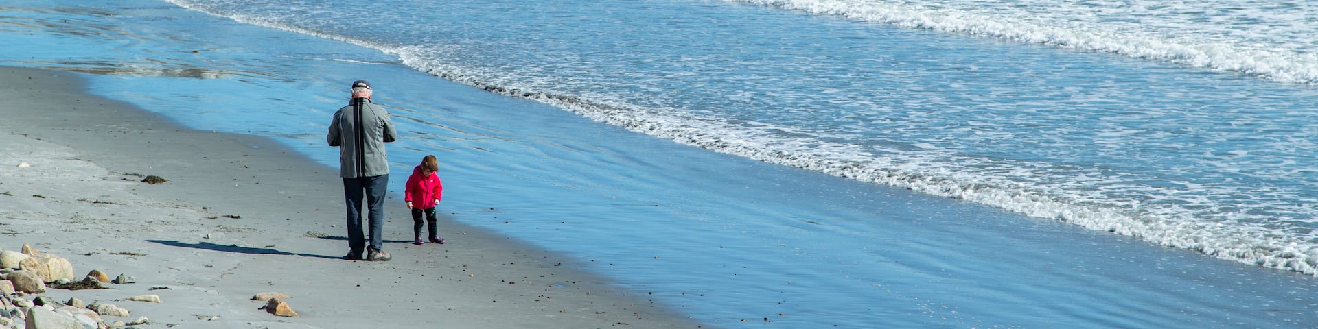 Long Sands Beach featuring general coastal views and a coastal town as well as a family