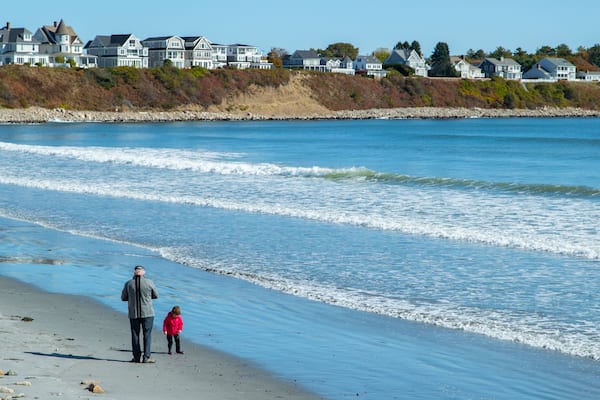 Long Sands Beach featuring general coastal views and a coastal town as well as a family