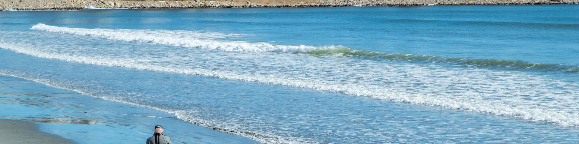 Long Sands Beach featuring general coastal views and a coastal town as well as a family