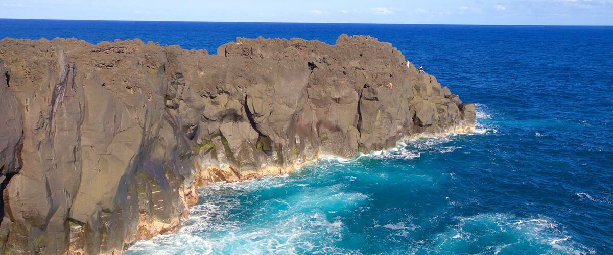 A rocky coastline with waves crashing against the rocks.