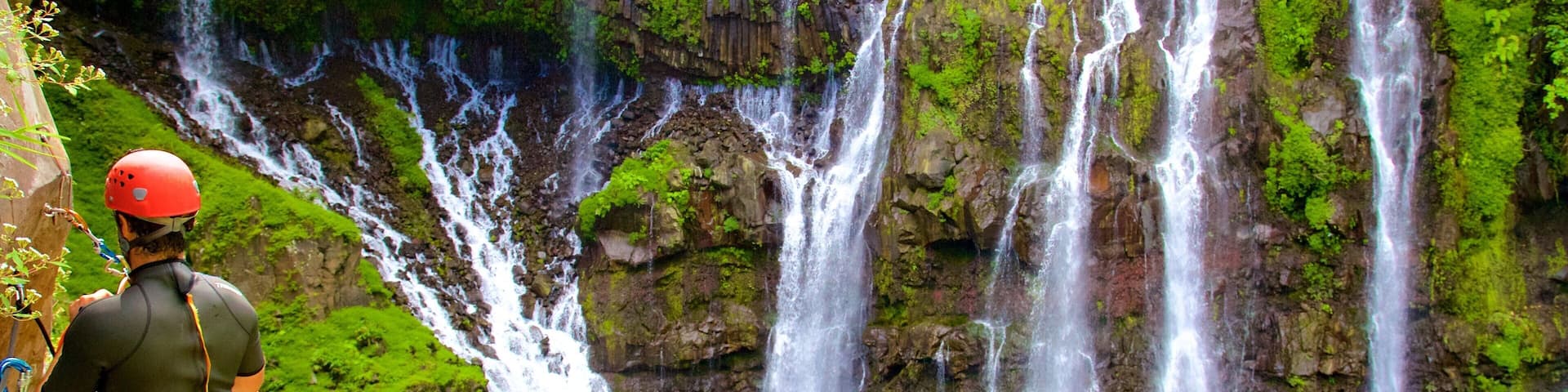 Reunion showing a waterfall and a lake or waterhole as well as an individual male