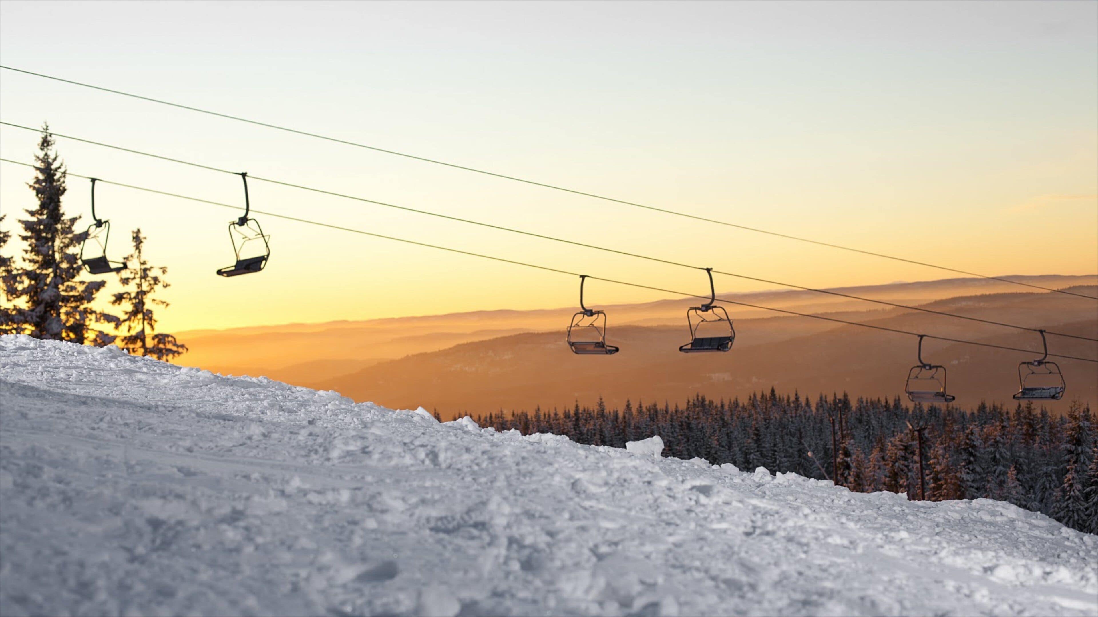 Oslo Winter Park featuring a gondola, snow and a sunset