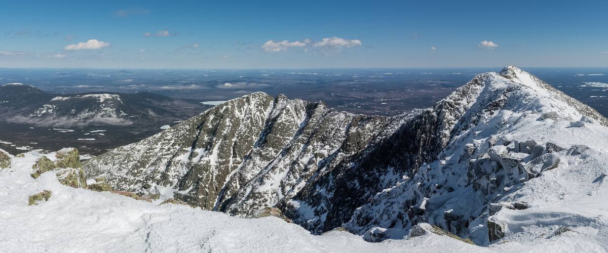 A snow-covered mountain peak with a clear sky.
