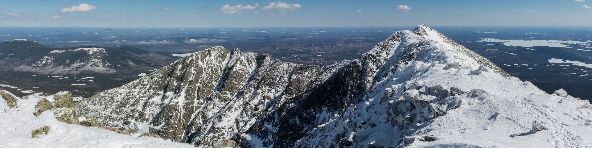 A snow-covered mountain peak with a clear sky.