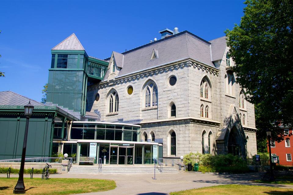 A historic building with a prominent tower and arched windows.