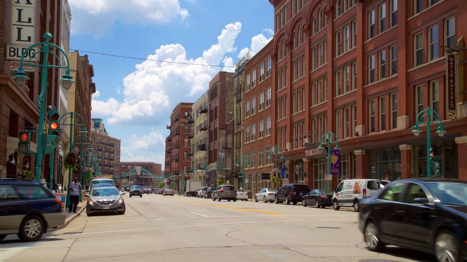 A street lined with red brick buildings, including a hotel and a pub.