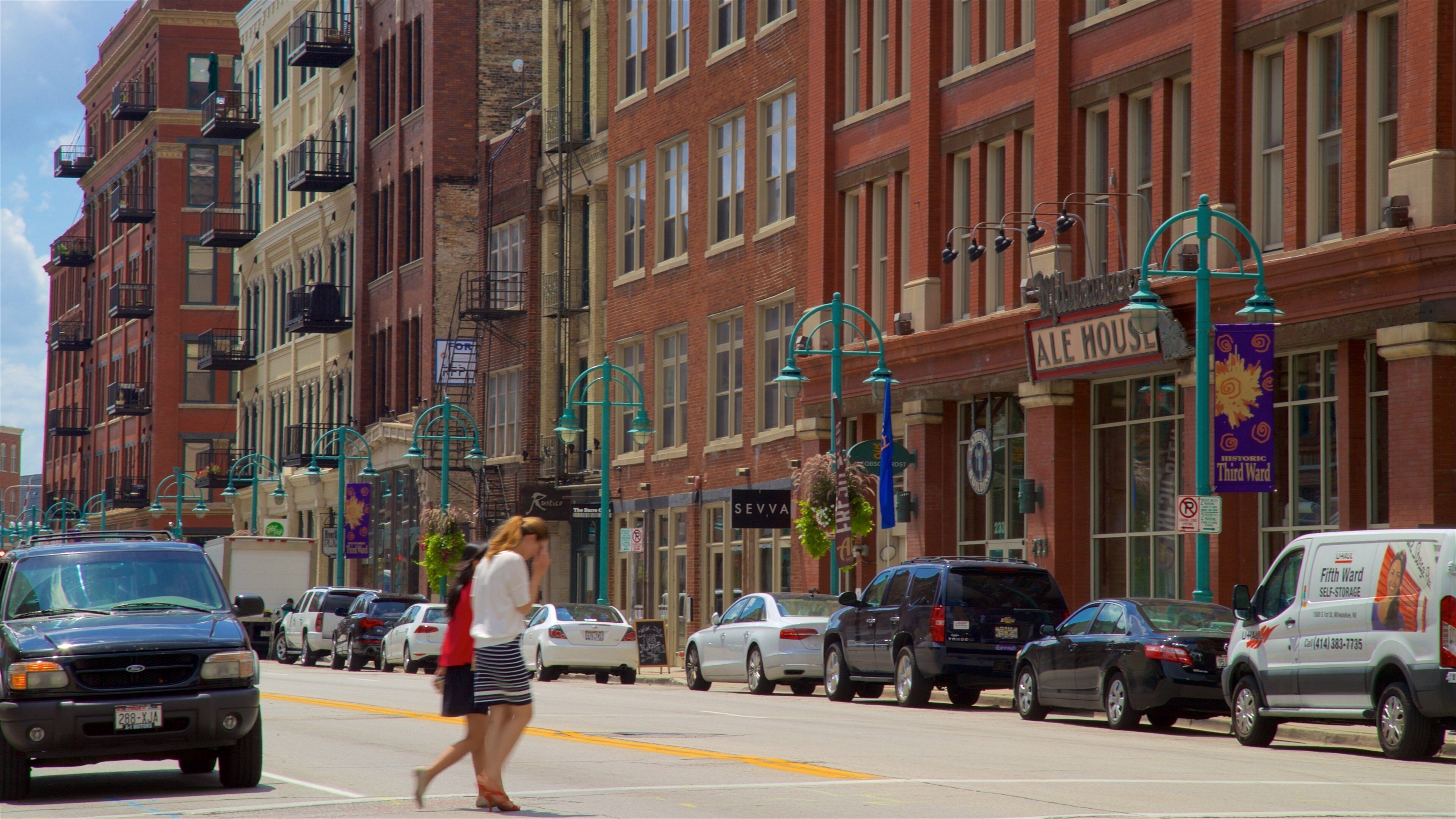 A street lined with historic brick buildings, including an Ale House.