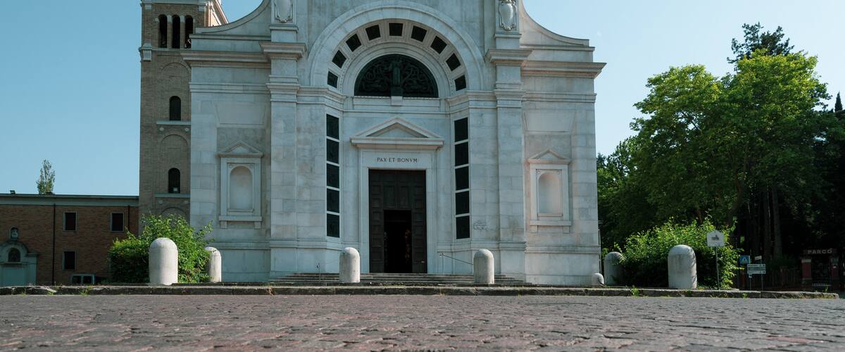 A historic building with a clock tower and inscriptions.