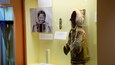 A museum exhibit with a display case containing a traditional garment and informational panels.
