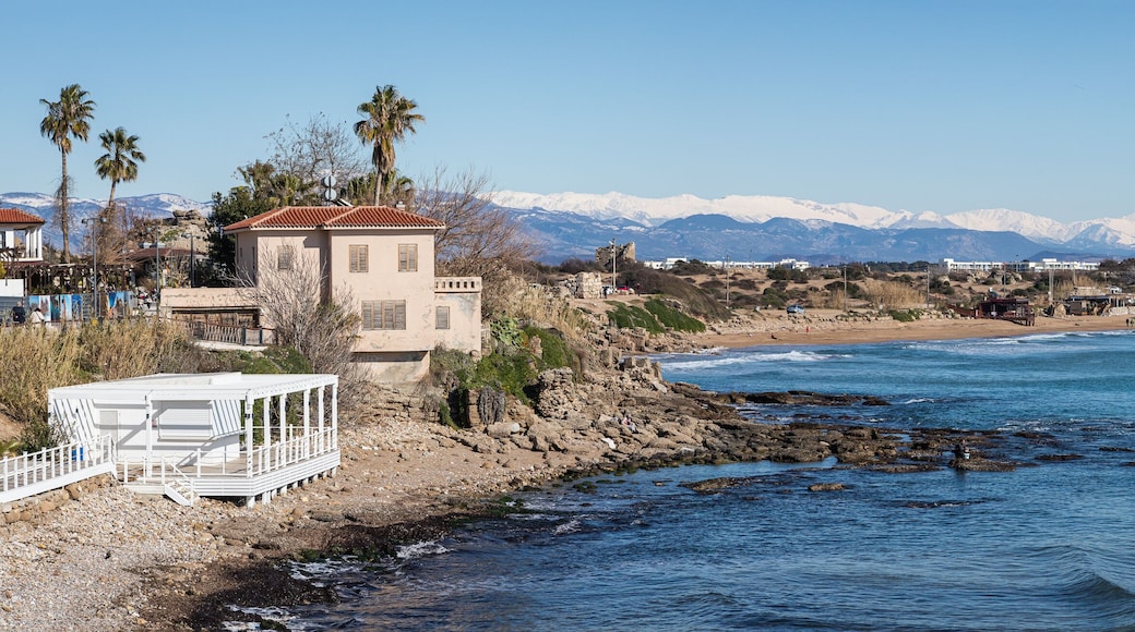 Old stone ancient houses full of green plants, cafe on the seashore in Turkey. Side is populer tourist destination in Turkey.