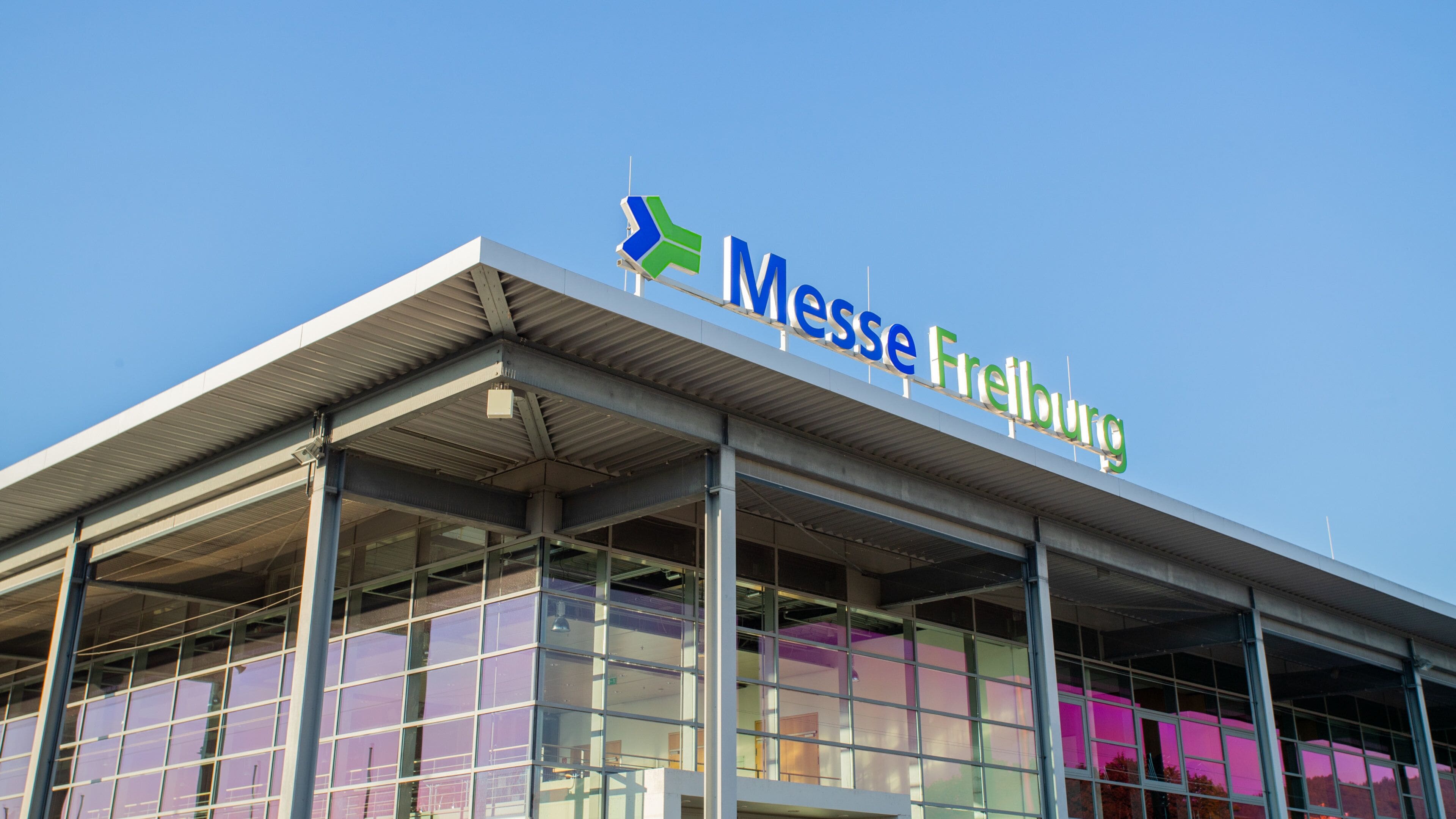 A modern building with a sign reading "Messe Freiburg".