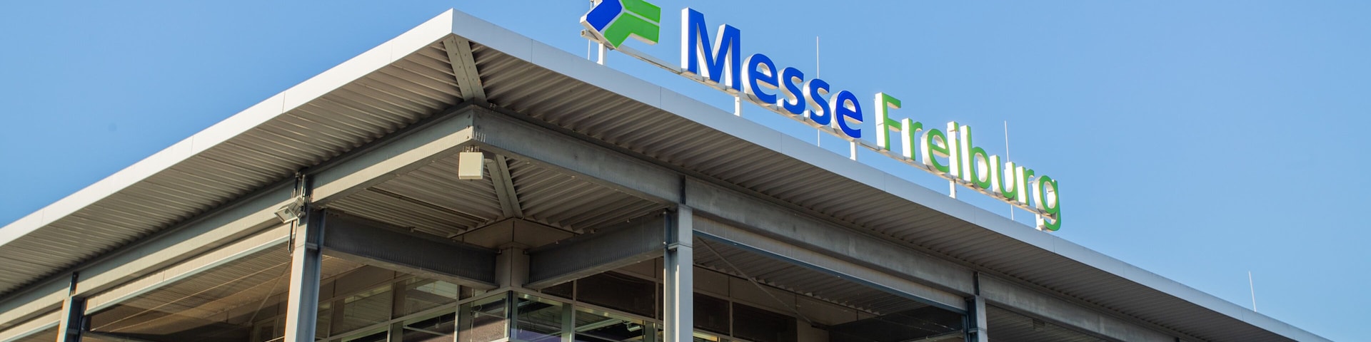 A modern building with a sign reading "Messe Freiburg".