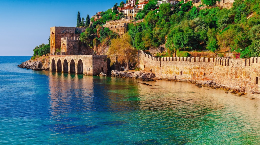 Landscape of ancient shipyard near of Kizil Kule tower in Alanya peninsula, Antalya district, Turkey, Asia. Famous tourist destination with high mountains. Part of ancient old Castle.