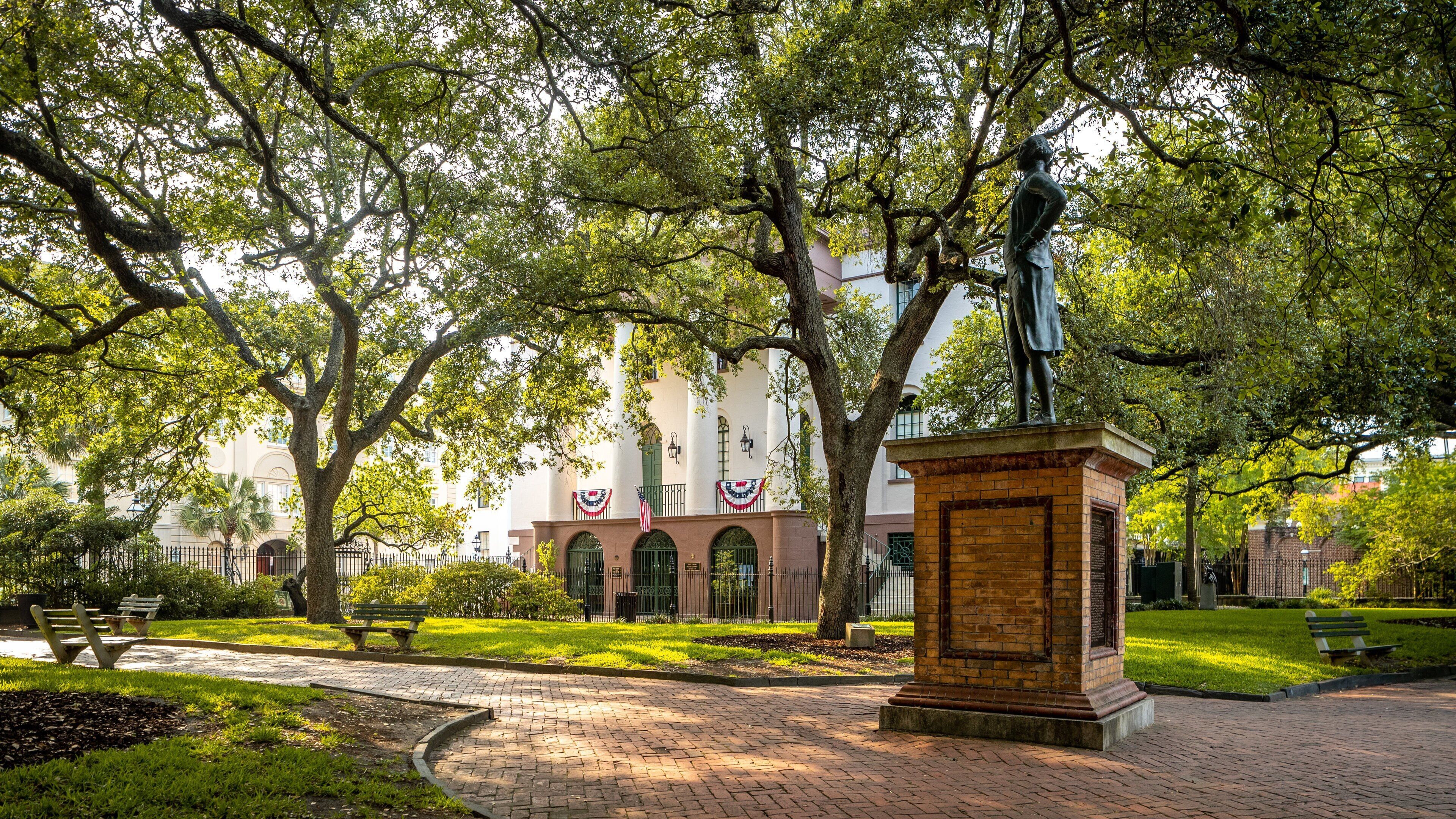 Washington Square which includes a garden and a statue or sculpture