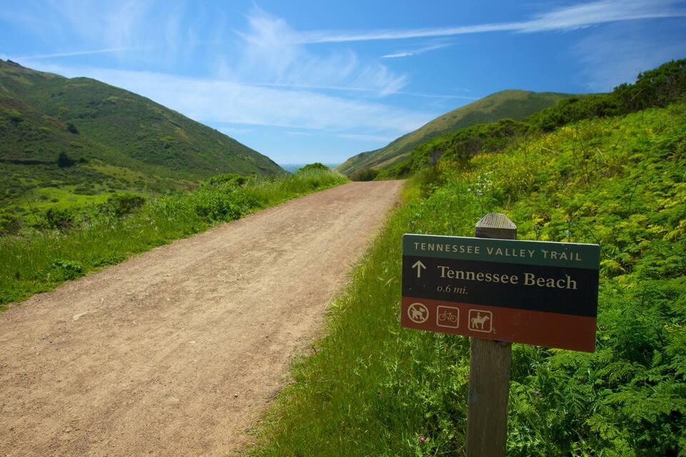 A dirt trail leading to Tennessee Beach, marked by a sign.