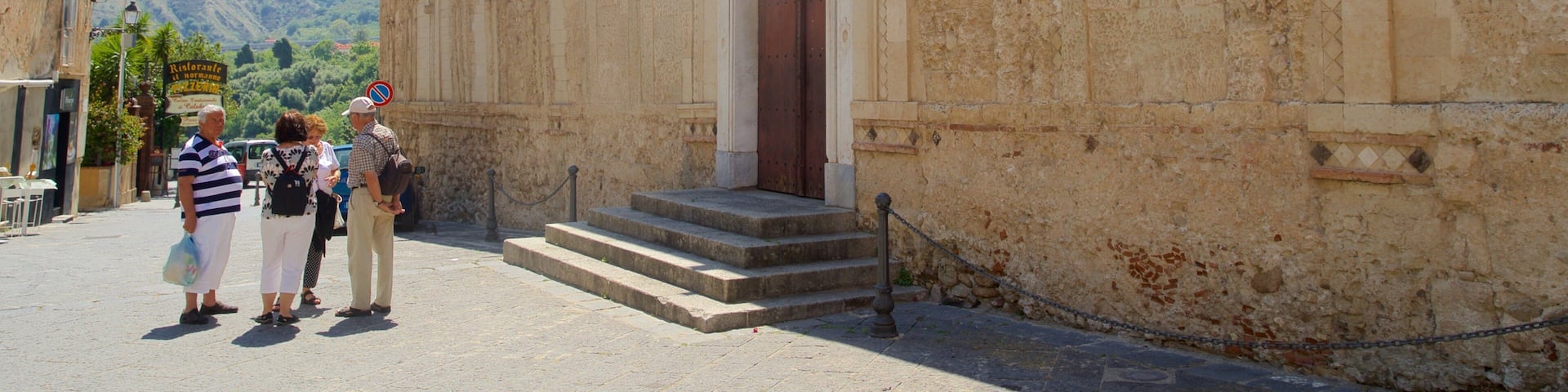 A historic building with a large wooden door and steps leading up to it.