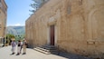 A historic building with a large wooden door and steps leading up to it.