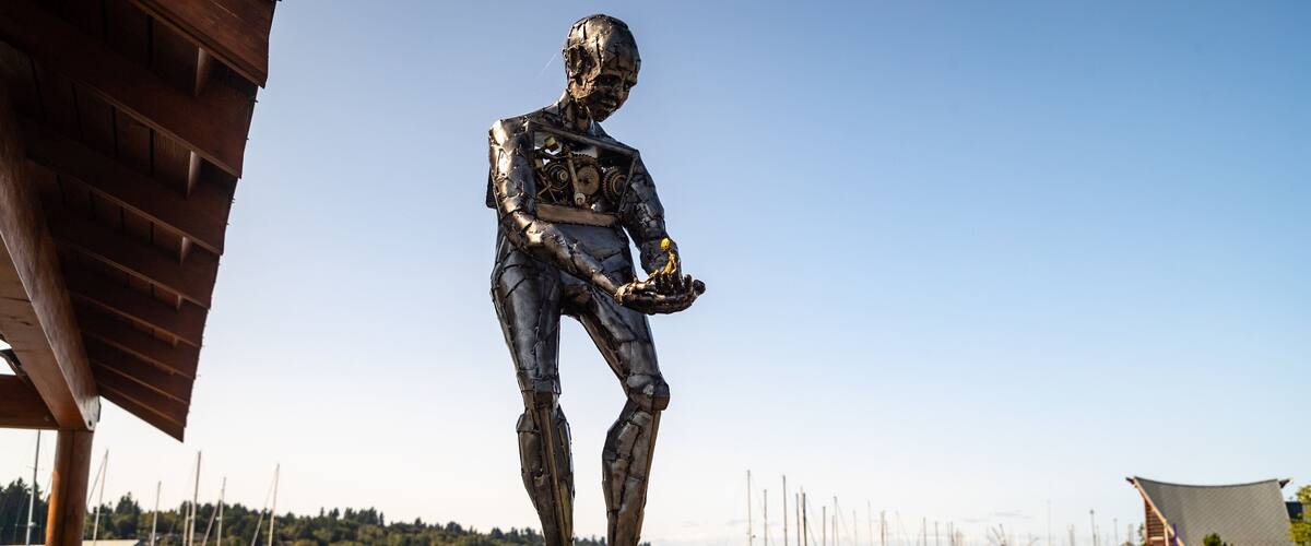 Percival Landing which includes outdoor art and a bay or harbor