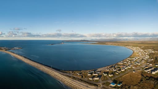Aerial panoramic view of a small town on the Atlantic Ocean Coast during a vibrant sunny sunset. Taken in Cow Head, Newfoundland, Canada.